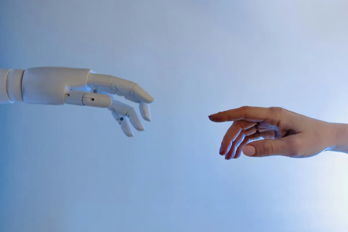 robot hand touching with human hand